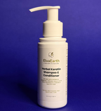 ElvaEarth Herbal Keratin Shampoo & Conditioner bottle on a blue background