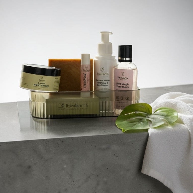 Collection of skincare products on a gray surface with a white towel and green leaf.